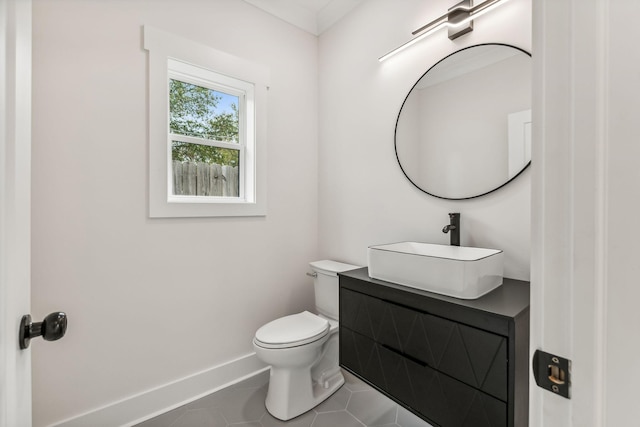 bathroom with tile patterned flooring, vanity, and toilet