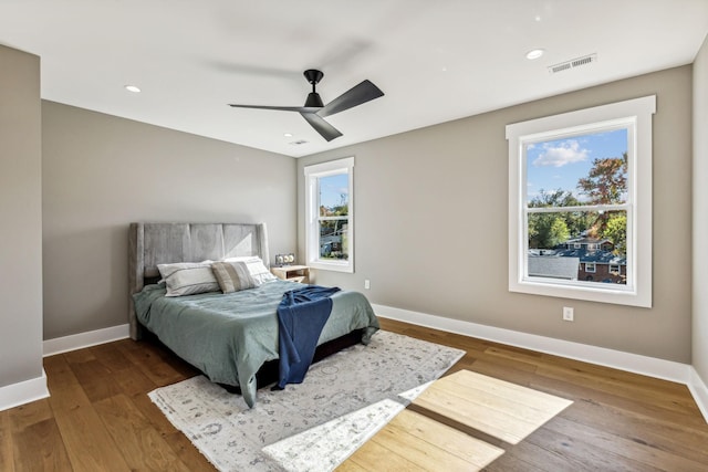 bedroom with ceiling fan and wood-type flooring