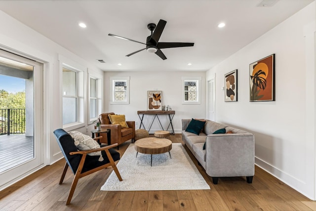 living room with hardwood / wood-style floors and ceiling fan