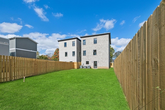 rear view of house featuring a yard