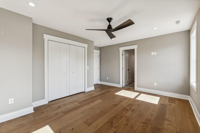 unfurnished bedroom featuring ceiling fan and hardwood / wood-style floors