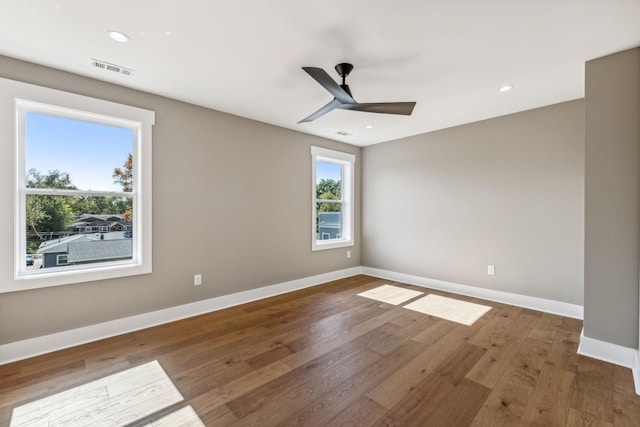 unfurnished room with wood-type flooring and ceiling fan