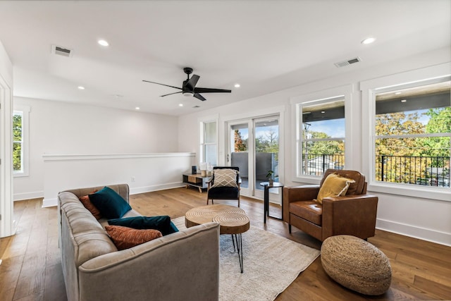 living room with hardwood / wood-style flooring and ceiling fan