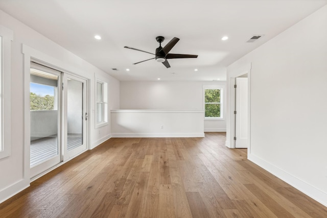 spare room with light hardwood / wood-style floors and ceiling fan