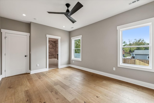 unfurnished bedroom with ensuite bathroom, ceiling fan, and light hardwood / wood-style floors