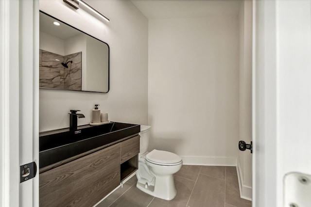 bathroom featuring tile patterned floors, toilet, and vanity