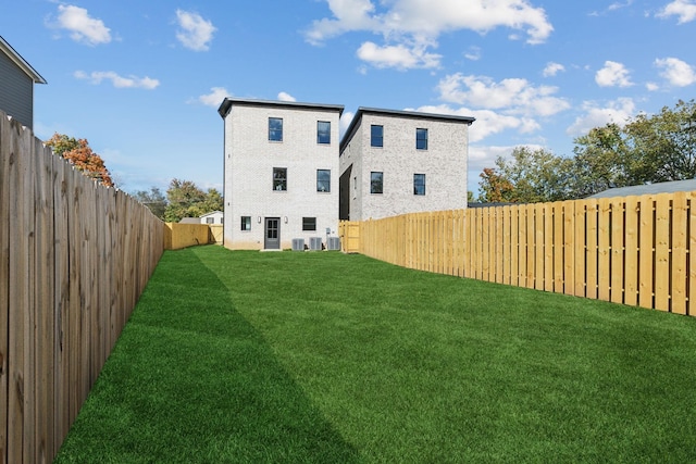 rear view of property with a lawn