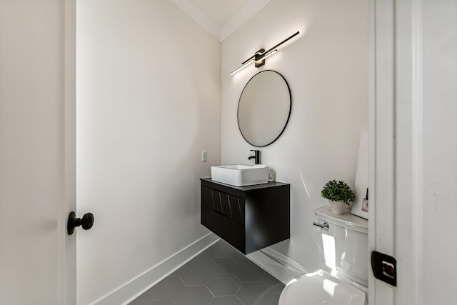 bathroom featuring vanity, tile patterned floors, and toilet