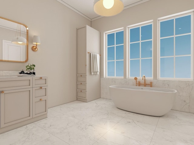 bathroom with crown molding, vanity, and a bathtub