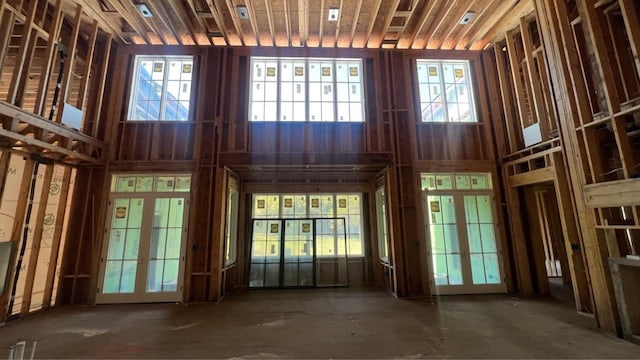 miscellaneous room featuring a towering ceiling