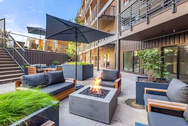 view of patio / terrace with an outdoor living space with a fire pit