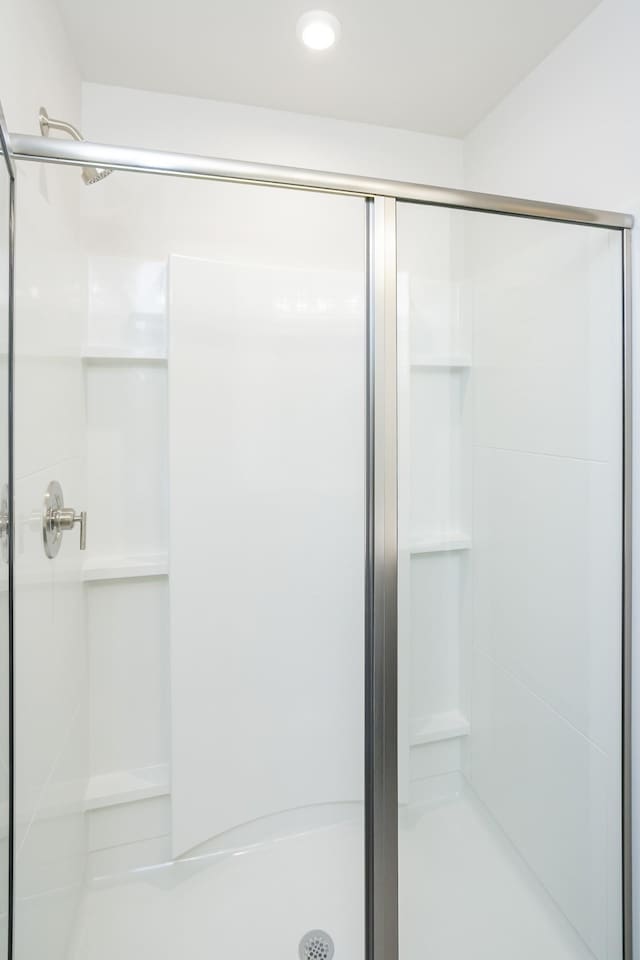 bathroom with a shower with door