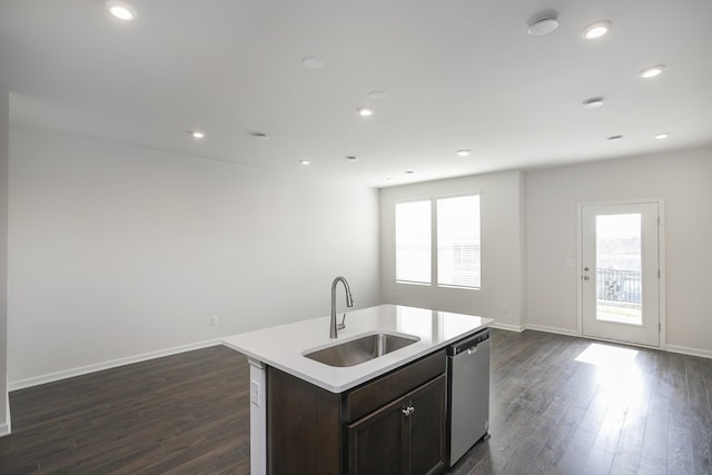 kitchen with stainless steel dishwasher, sink, a kitchen island with sink, and a wealth of natural light