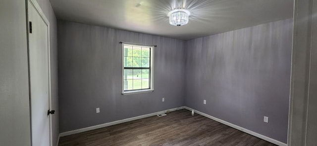 empty room with dark hardwood / wood-style flooring