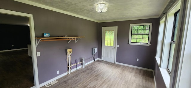 laundry area featuring hardwood / wood-style floors and a textured ceiling