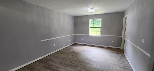 unfurnished room with wood-type flooring