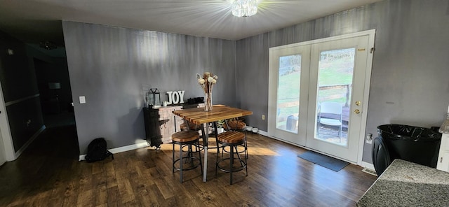 dining area with dark hardwood / wood-style flooring and french doors