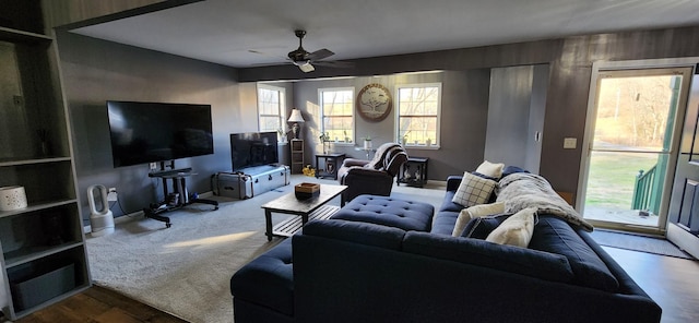 carpeted living room with ceiling fan