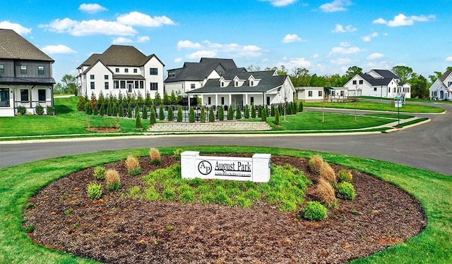 community / neighborhood sign with a yard