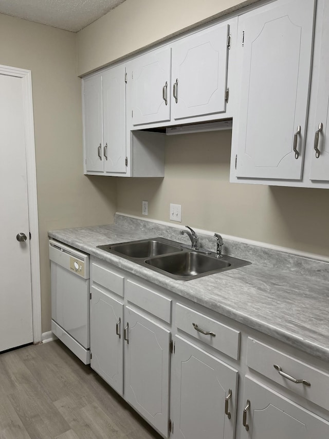 kitchen featuring white cabinetry, sink, and dishwasher