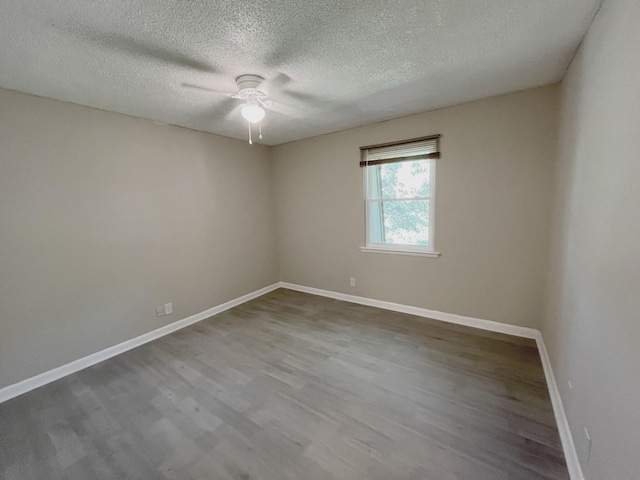 spare room featuring wood-type flooring, ceiling fan, and a textured ceiling