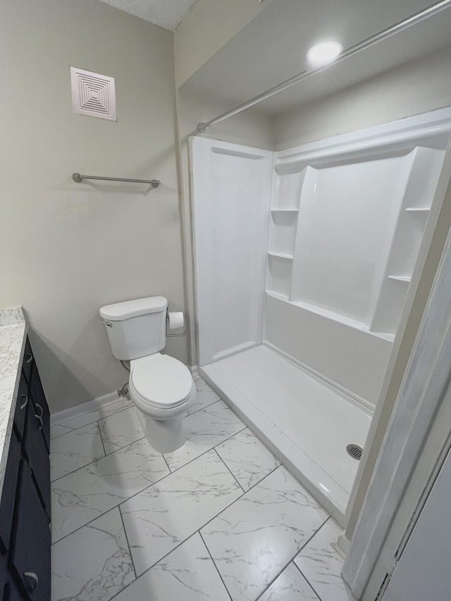 bathroom with vanity, toilet, and walk in shower