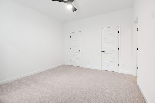 carpeted spare room with ceiling fan