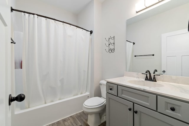 full bathroom with vanity, hardwood / wood-style flooring, toilet, and shower / bathtub combination with curtain