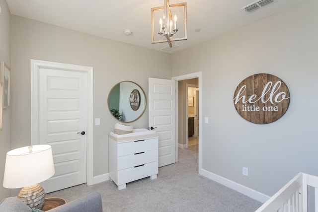 carpeted bedroom featuring an inviting chandelier