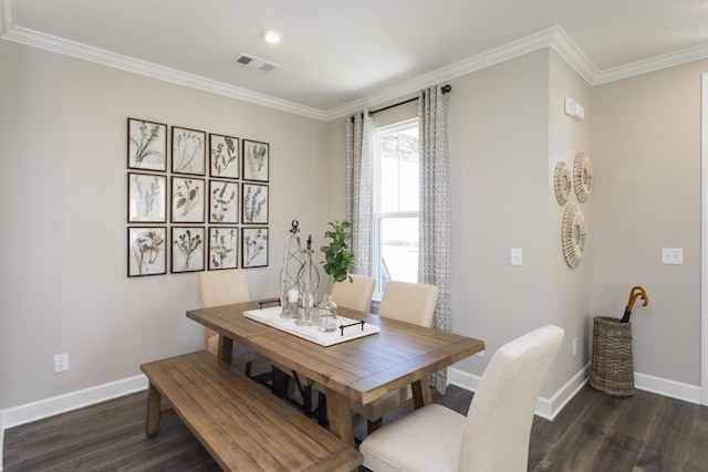 dining space with dark wood-type flooring and ornamental molding