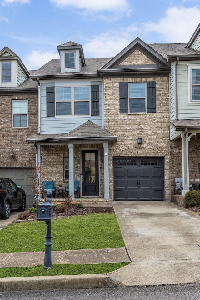 multi unit property with a garage and a front lawn