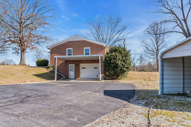 view of side of home with a carport and a garage