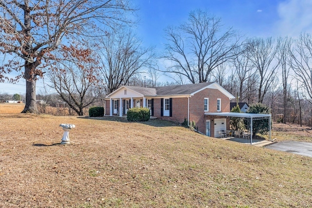 view of front of house with a carport, a garage, covered porch, and a front lawn