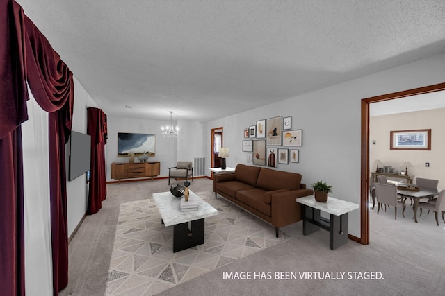 living room featuring a notable chandelier, light colored carpet, and a textured ceiling