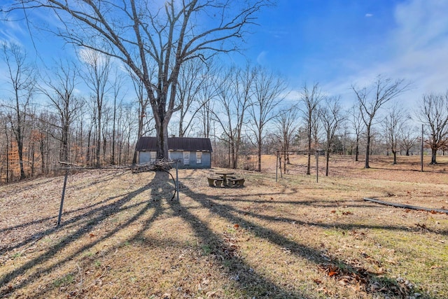 view of yard with a rural view and an outbuilding