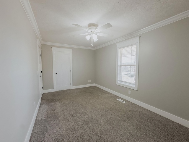 carpeted spare room featuring crown molding, ceiling fan, and a textured ceiling