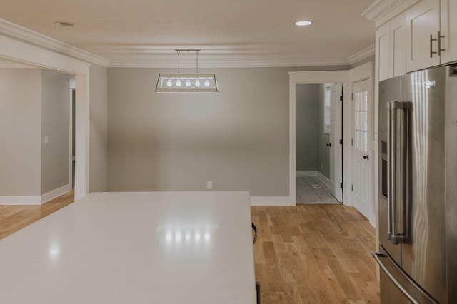 unfurnished dining area with ornamental molding and light hardwood / wood-style flooring