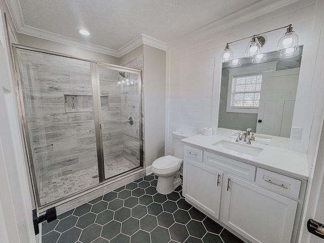 bathroom with crown molding, vanity, toilet, and a shower with door