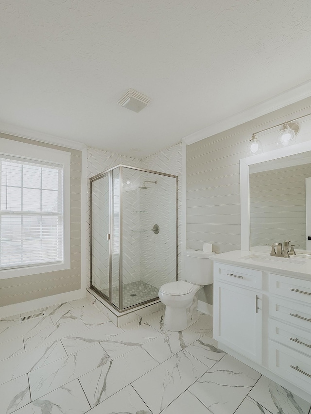 bathroom with vanity, a textured ceiling, a shower with shower door, and toilet