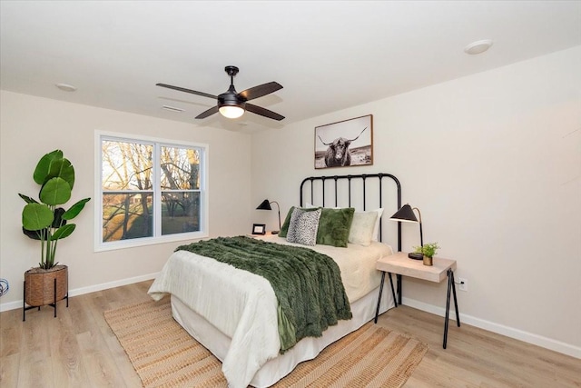 bedroom with ceiling fan and light hardwood / wood-style flooring