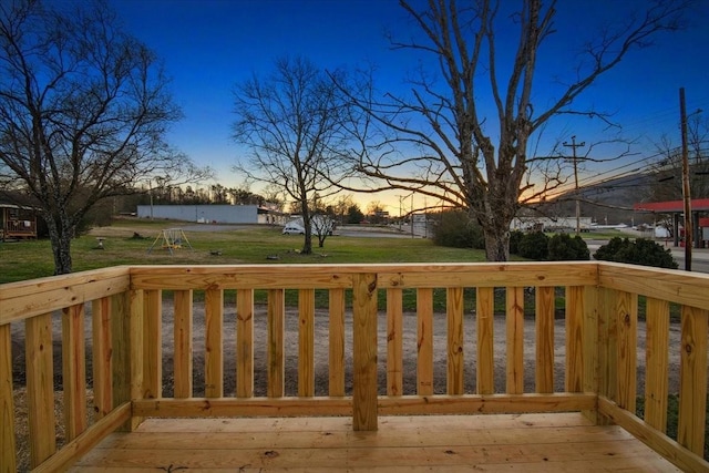 deck at dusk with a lawn