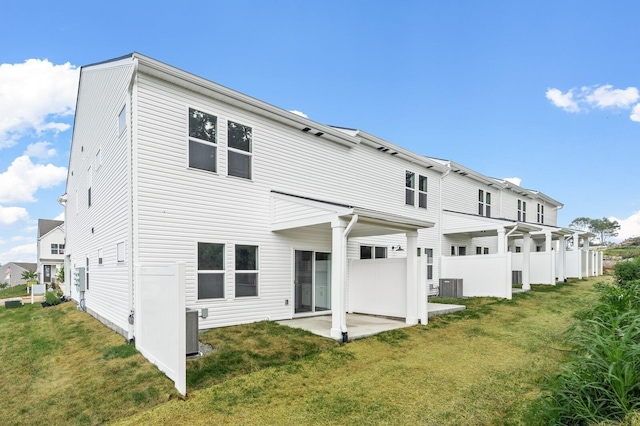 back of house featuring a yard, a patio, and central air condition unit