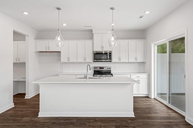 kitchen featuring white cabinetry, sink, stainless steel appliances, and an island with sink