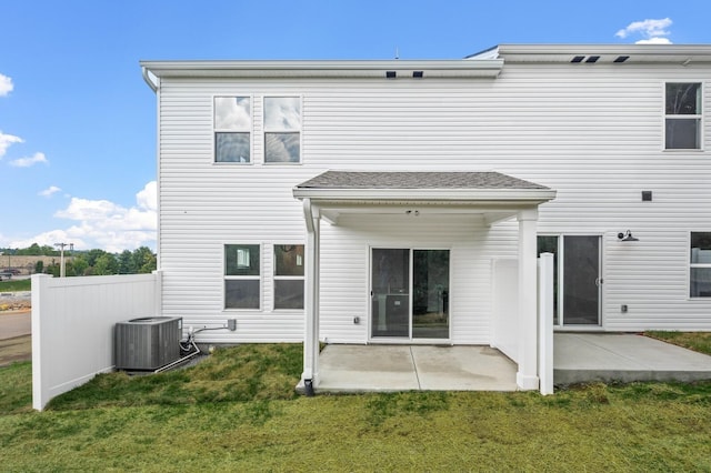 back of house featuring a yard, central AC, and a patio area