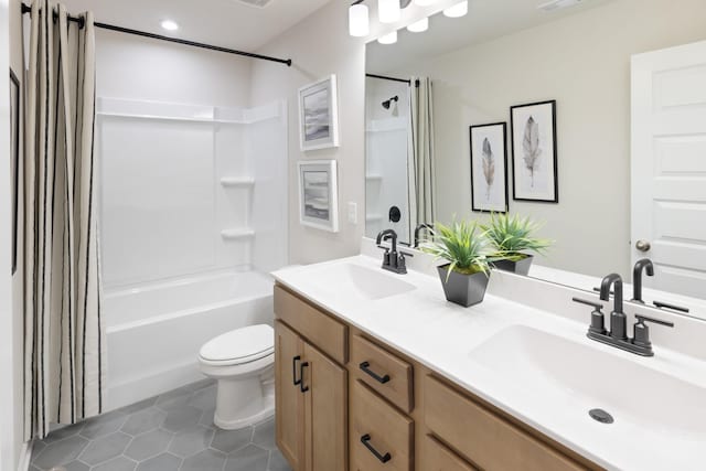 full bathroom with vanity, shower / bathtub combination with curtain, tile patterned floors, and toilet