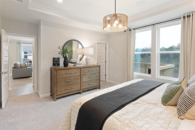 bedroom with ornamental molding and light carpet