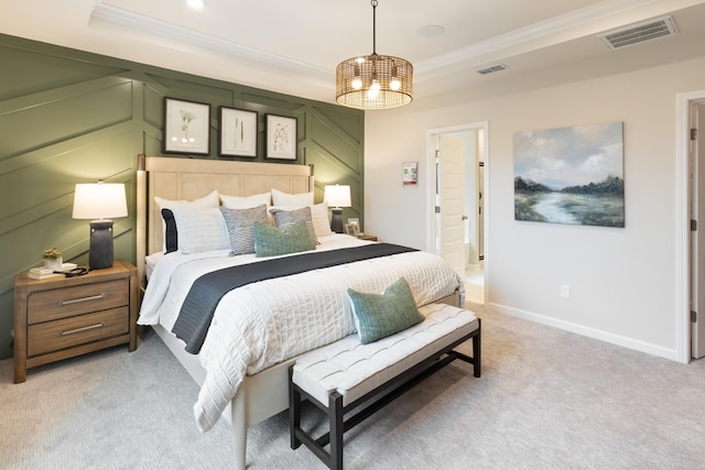 carpeted bedroom with a raised ceiling and crown molding