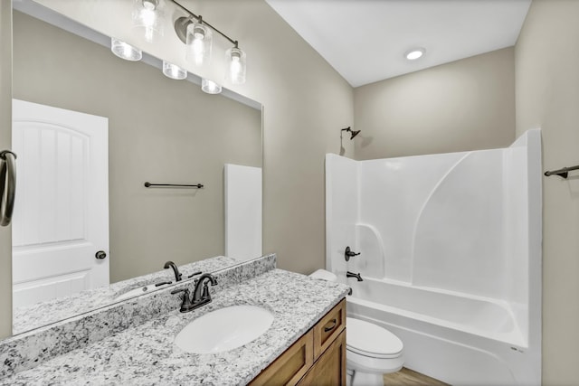 full bathroom with vanity, shower / tub combination, and toilet