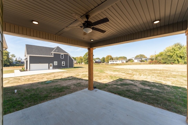 view of patio with a garage and ceiling fan