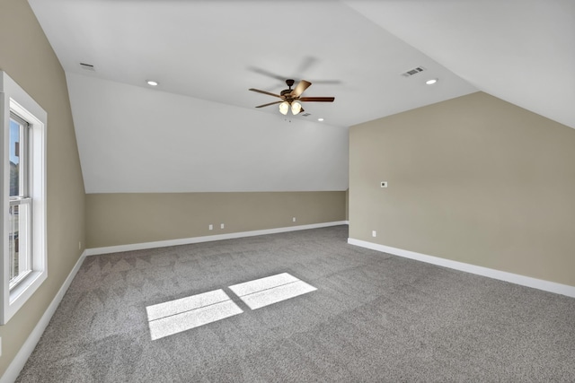 additional living space with lofted ceiling, a wealth of natural light, and carpet flooring